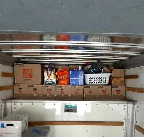 Overhead shelf fully packed with small boxes